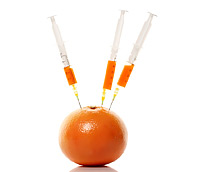orange with syringes sticking out of it to represent high dose vitamin c